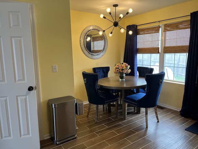 135 Bucks Hill Rd Apt 8, Waterbury, CT 06704 - dining area with dark wood finished floors, baseboards, and a notable chandelier