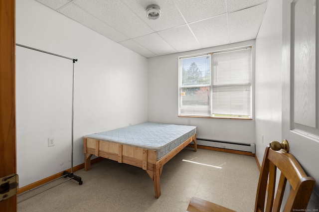 24 Fort Shantok Rd, Montville, CT 06382 - bedroom with baseboards, a baseboard heating unit, tile patterned floors, and a paneled ceiling