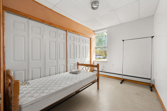 24 Fort Shantok Rd, Montville, CT 06382 - bedroom with baseboards, baseboard heating, tile patterned floors, and a paneled ceiling