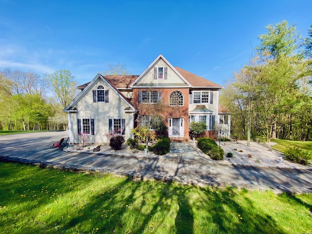 back of property featuring a yard