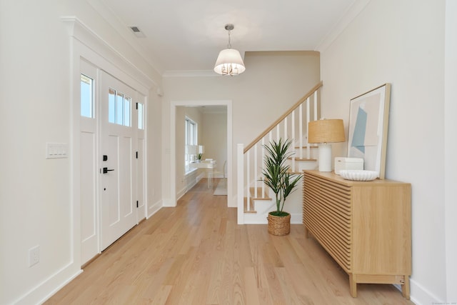 137 Millard St, Fairfield, CT 06824 - entryway featuring light wood-style floors, stairs, and ornamental molding