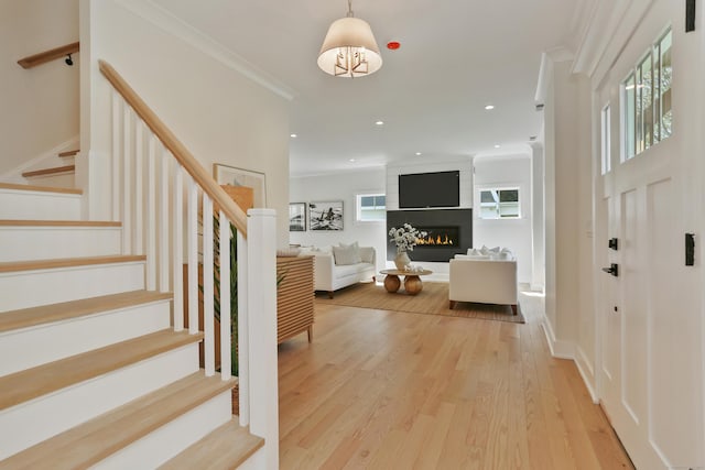 137 Millard St, Fairfield, CT 06824 - entrance foyer with stairs, wood finished floors, a fireplace, ornamental molding, and recessed lighting