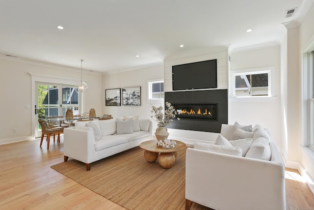 137 Millard St, Fairfield, CT 06824 - living area featuring ornamental molding, light wood-style flooring, a large fireplace, recessed lighting, and a chandelier
