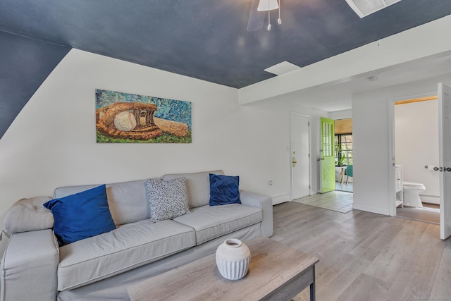 living area with ceiling fan, wood finished floors, and visible vents