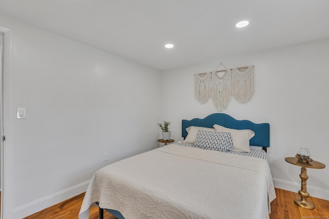 bedroom featuring baseboards, recessed lighting, and wood finished floors