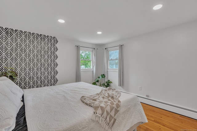 bedroom with recessed lighting and wood finished floors