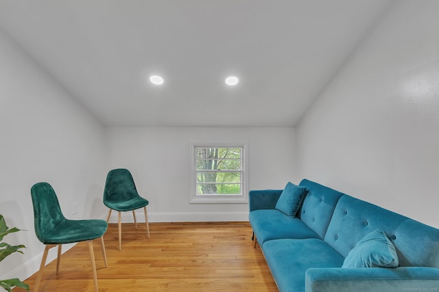 living room with baseboards, recessed lighting, lofted ceiling, and wood finished floors