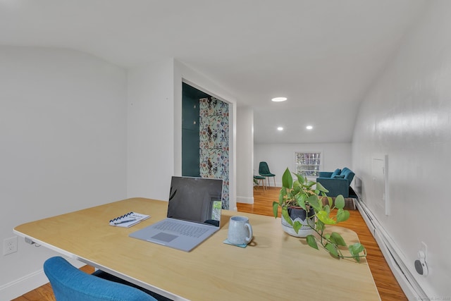 office featuring wood finished floors, baseboards, a baseboard heating unit, lofted ceiling, and recessed lighting