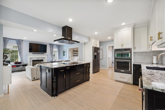 9 Baldwin Dr, Farmington, CT 06032 - kitchen featuring a sink, refrigerator with ice dispenser, island range hood, black electric stovetop, and dark cabinetry