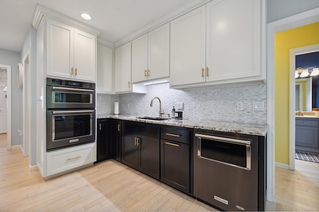 9 Baldwin Dr, Farmington, CT 06032 - kitchen with a sink, double oven, white cabinets, light wood-style flooring, and recessed lighting