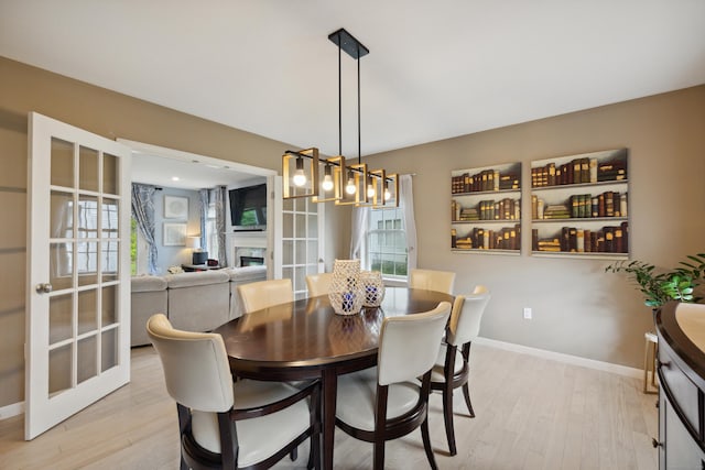 9 Baldwin Dr, Farmington, CT 06032 - dining space with light wood finished floors, baseboards, and a fireplace