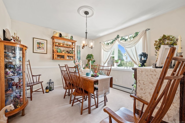 dining area with a baseboard radiator, light colored carpet, and a chandelier