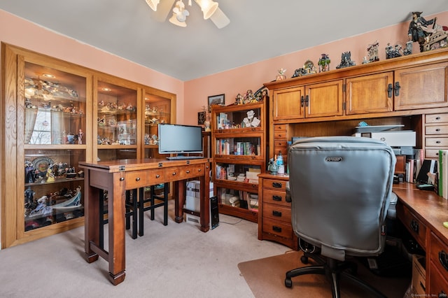 home office featuring a ceiling fan and light carpet