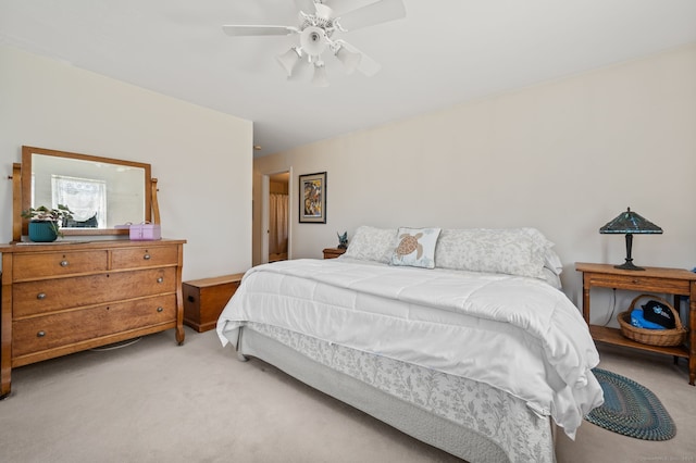 bedroom featuring light colored carpet and ceiling fan