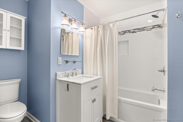 bathroom with toilet, shower / tub combo, and vanity