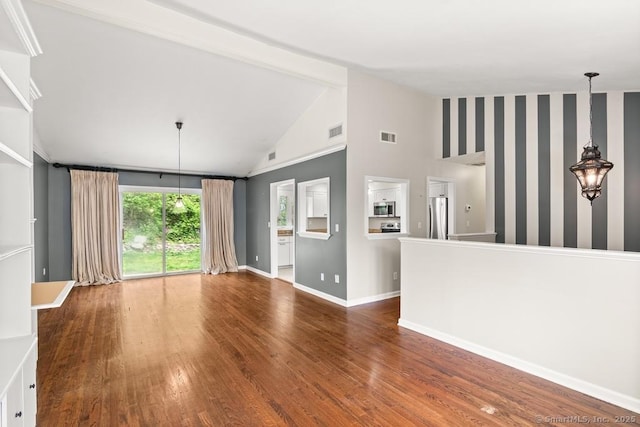 unfurnished living room with baseboards, visible vents, and wood finished floors