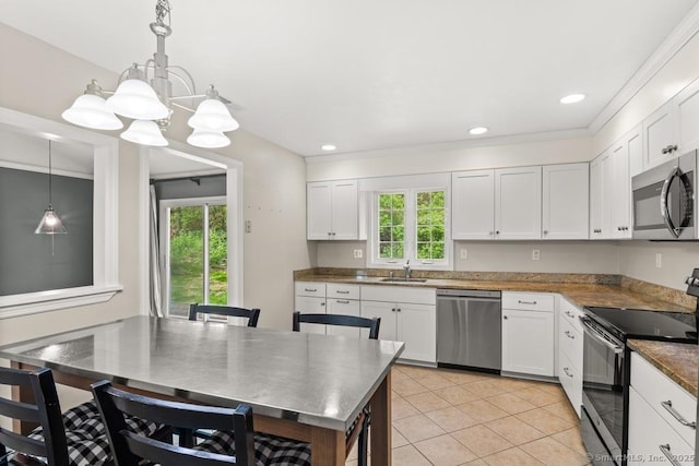 kitchen featuring light tile patterned flooring, an inviting chandelier, white cabinetry, hanging light fixtures, and appliances with stainless steel finishes