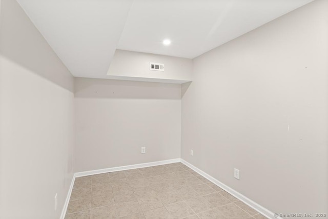 below grade area featuring baseboards, recessed lighting, and visible vents