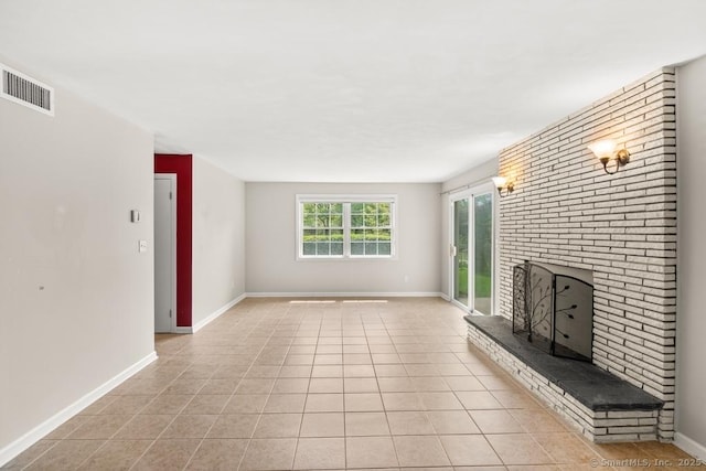 unfurnished living room featuring light tile patterned floors, visible vents, a fireplace, and baseboards