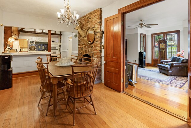 45 Roseland Park Rd, Woodstock, CT 06281 - dining space featuring light wood-style floors, ceiling fan, a chandelier, and a fireplace