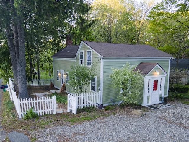 45 Roseland Park Rd, Woodstock, CT 06281 - view of front of house with a chimney, fence, and a shingled roof