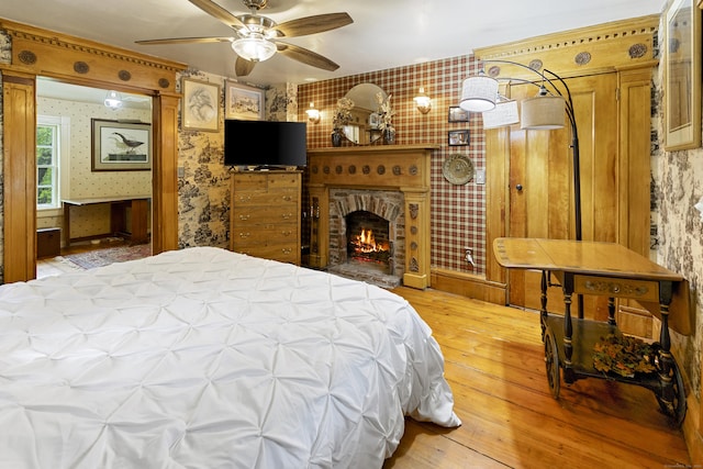 45 Roseland Park Rd, Woodstock, CT 06281 - bedroom with wallpapered walls, hardwood / wood-style floors, and a brick fireplace