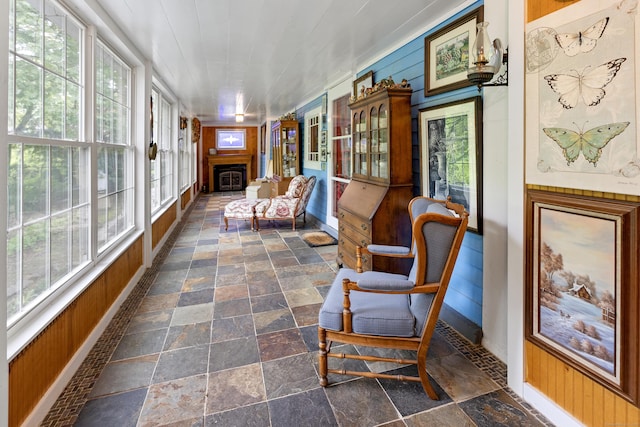 45 Roseland Park Rd, Woodstock, CT 06281 - sunroom with stone tile floors, healthy amount of natural light, baseboards, and wooden walls