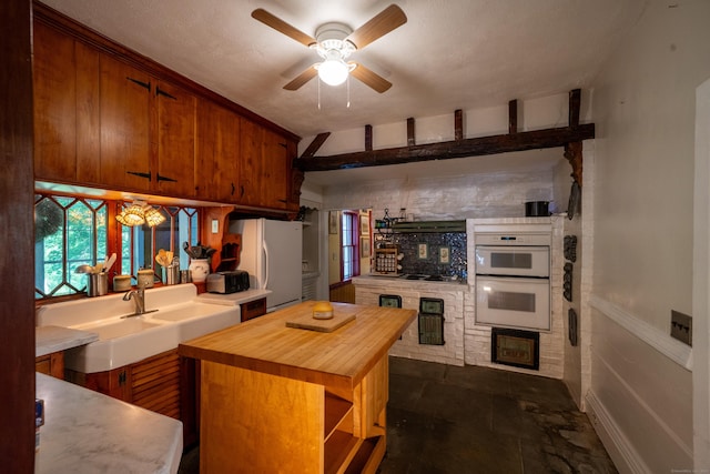 45 Roseland Park Rd, Woodstock, CT 06281 - kitchen featuring butcher block countertops, white appliances, brown cabinetry, ceiling fan, and a kitchen island