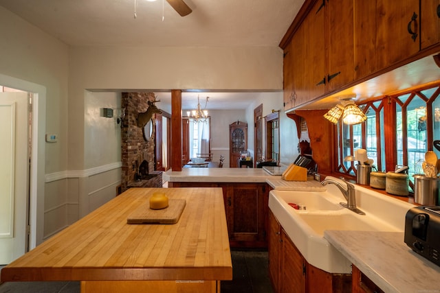 45 Roseland Park Rd, Woodstock, CT 06281 - kitchen featuring wooden counters, a ceiling fan, a chandelier, brown cabinets, and a wainscoted wall