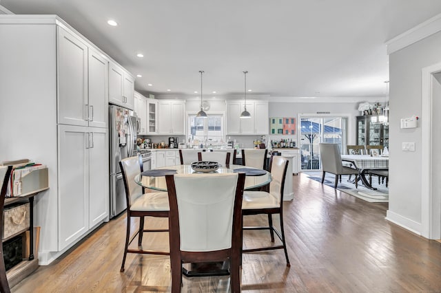 74 Sterling St, Fairfield, CT 06825 - dining area featuring light wood-style floors, ornamental molding, and recessed lighting