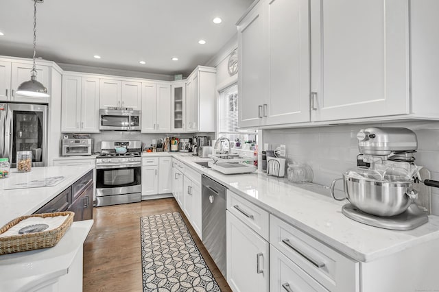 74 Sterling St, Fairfield, CT 06825 - kitchen with white cabinetry, stainless steel appliances, and recessed lighting