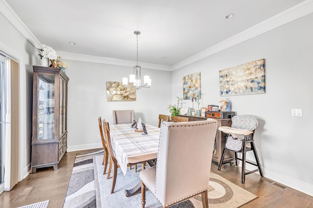 74 Sterling St, Fairfield, CT 06825 - dining area with ornamental molding, a notable chandelier, visible vents, and wood finished floors