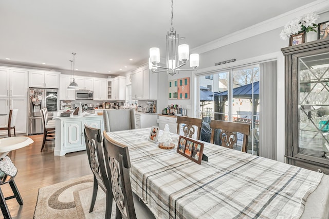74 Sterling St, Fairfield, CT 06825 - dining area featuring crown molding, light wood-type flooring, a chandelier, and recessed lighting