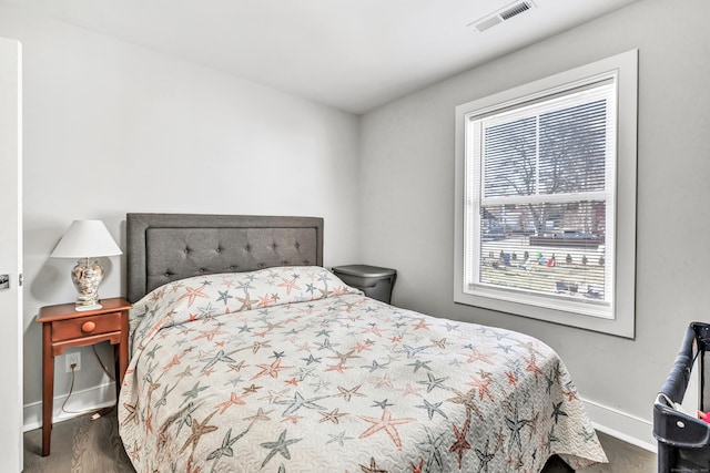 74 Sterling St, Fairfield, CT 06825 - bedroom with multiple windows, visible vents, wood finished floors, and baseboards
