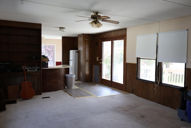 325 Kelly Rd Unit Vt44, Vernon, CT 06066 - interior space featuring freestanding refrigerator, open shelves, light carpet, ceiling fan, and wooden walls