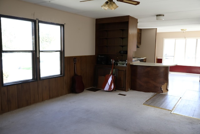 325 Kelly Rd Unit Vt44, Vernon, CT 06066 - kitchen with a wainscoted wall, ceiling fan, wood walls, and a wealth of natural light