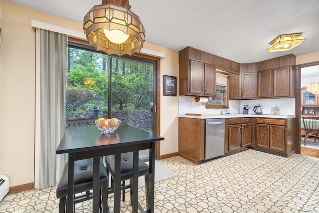 214 Candlewyck Dr, Newington, CT 06111 - kitchen featuring stainless steel dishwasher, baseboards, light countertops, and a baseboard heating unit
