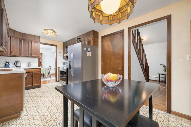214 Candlewyck Dr, Newington, CT 06111 - kitchen featuring light floors, a baseboard heating unit, baseboards, light countertops, and appliances with stainless steel finishes