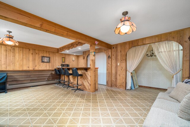 214 Candlewyck Dr, Newington, CT 06111 - kitchen with tile patterned floors, wood walls, stainless steel microwave, and a baseboard radiator