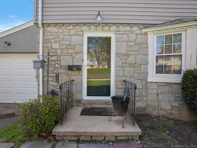 134 Painter Ave, West Haven, CT 06516 - entrance to property with an attached garage and stone siding
