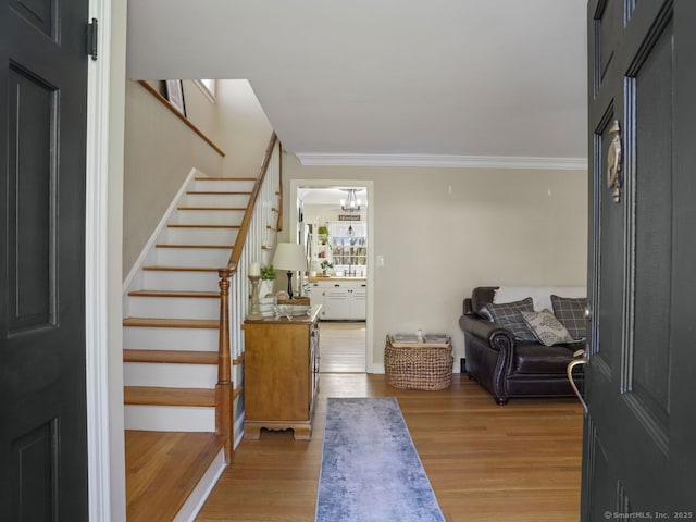 134 Painter Ave, West Haven, CT 06516 - entrance foyer featuring stairs, a chandelier, ornamental molding, and wood finished floors
