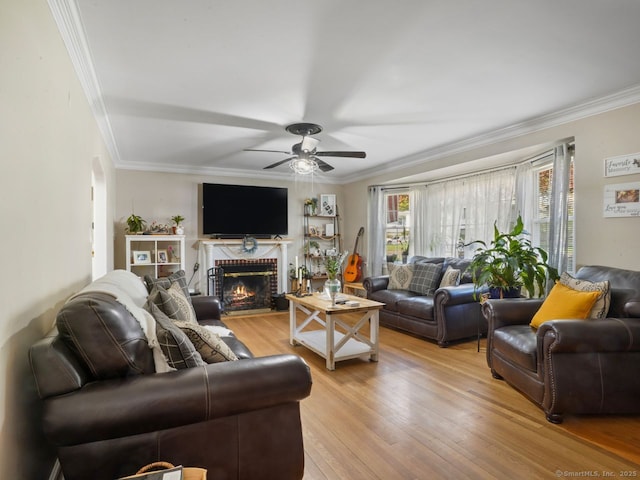 134 Painter Ave, West Haven, CT 06516 - living area featuring ornamental molding, a ceiling fan, light wood-type flooring, and a brick fireplace