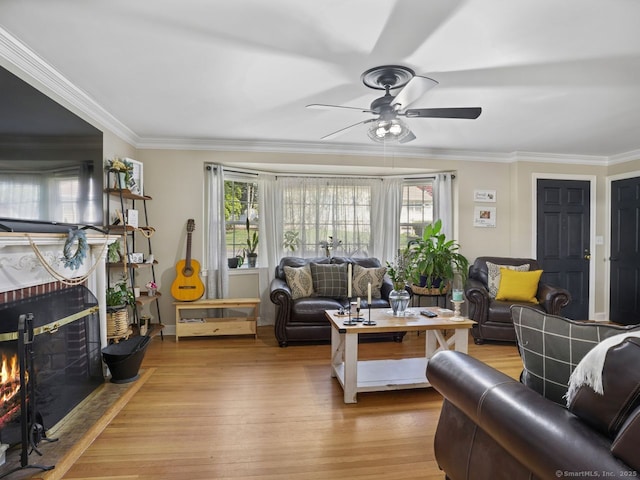 134 Painter Ave, West Haven, CT 06516 - living room with plenty of natural light, a ceiling fan, a brick fireplace, and wood finished floors