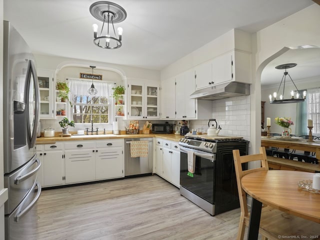 134 Painter Ave, West Haven, CT 06516 - kitchen featuring a sink, appliances with stainless steel finishes, under cabinet range hood, and a chandelier
