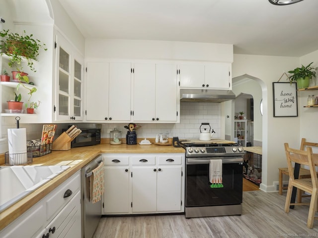 134 Painter Ave, West Haven, CT 06516 - kitchen with under cabinet range hood, stainless steel appliances, arched walkways, and light countertops