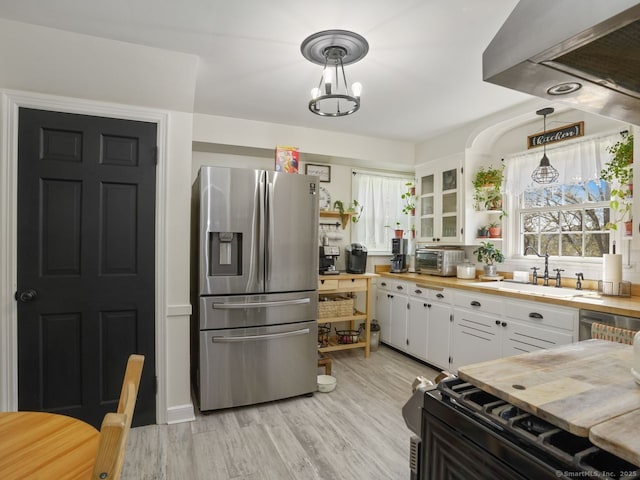 134 Painter Ave, West Haven, CT 06516 - kitchen featuring white cabinets, open shelves, stainless steel fridge, a sink, and wooden counters