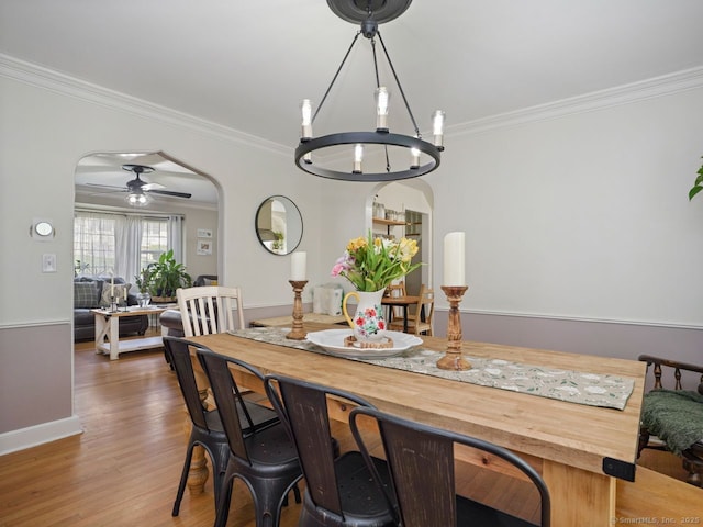 134 Painter Ave, West Haven, CT 06516 - dining space with crown molding, arched walkways, ceiling fan, and wood finished floors