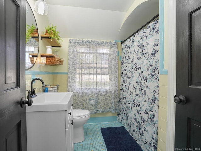 134 Painter Ave, West Haven, CT 06516 - full bathroom featuring wainscoting, vanity, toilet, tile patterned floors, and tile walls