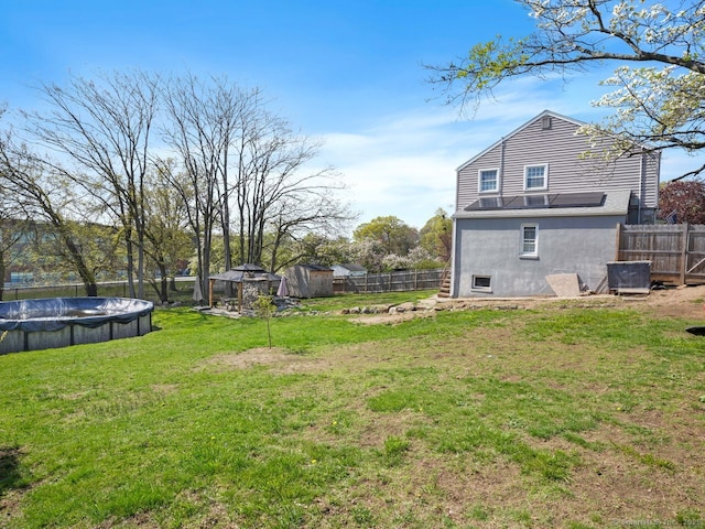 134 Painter Ave, West Haven, CT 06516 - view of yard featuring a fenced backyard, a fenced in pool, an outbuilding, and a shed