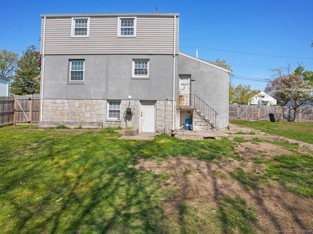 134 Painter Ave, West Haven, CT 06516 - back of property featuring a lawn, fence, and stucco siding